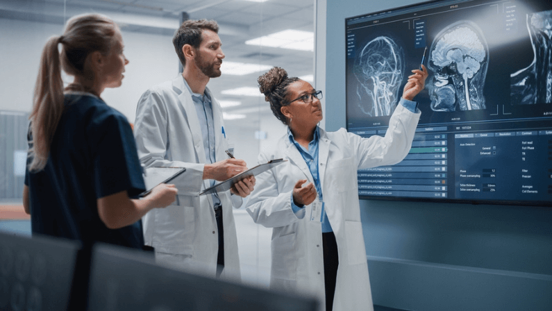 Medical Science Hospital Lab Meeting: Diverse Team of Neurologists, Neuroscientists, Neurosurgeon Consult TV Screen Showing MRI Scan with Brain Images, Talk About Treatment Metho