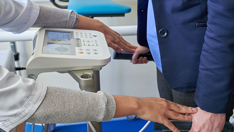 Close up of woman Body Composition Analysis by doctor before Fitness Activity. Woman Checking body with Body Composition Analysis machine. Health care, fitness and weight loss