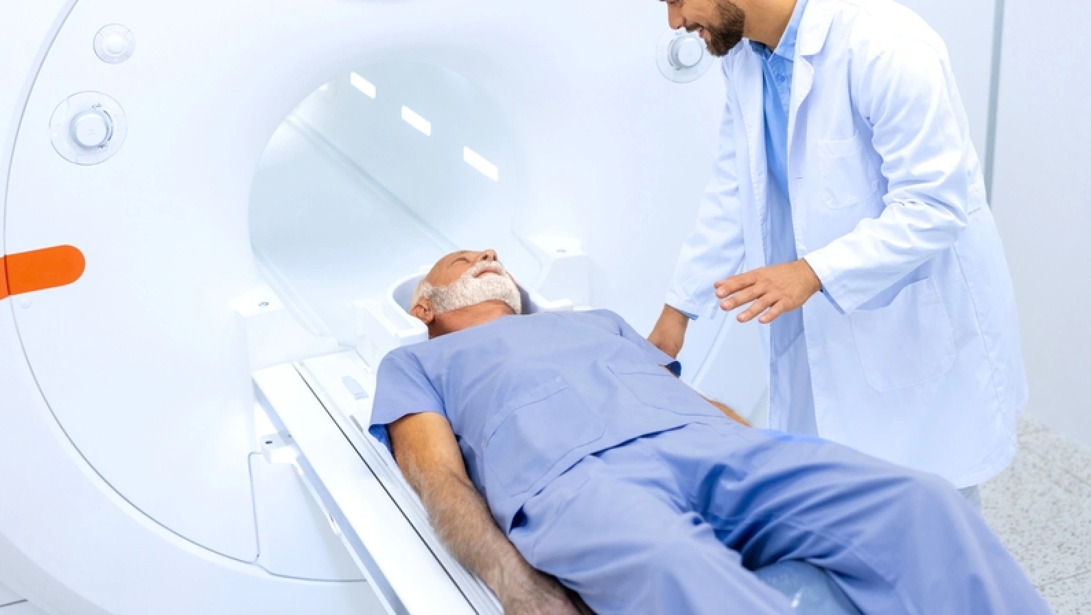 Experienced radiologist encouraging elderly patients before MRI or CT scan procedure in hospital.